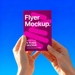 A6 flyer held in two hands against a blue background