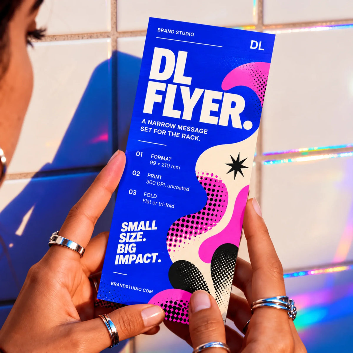 Blue DL flyer held in two hands